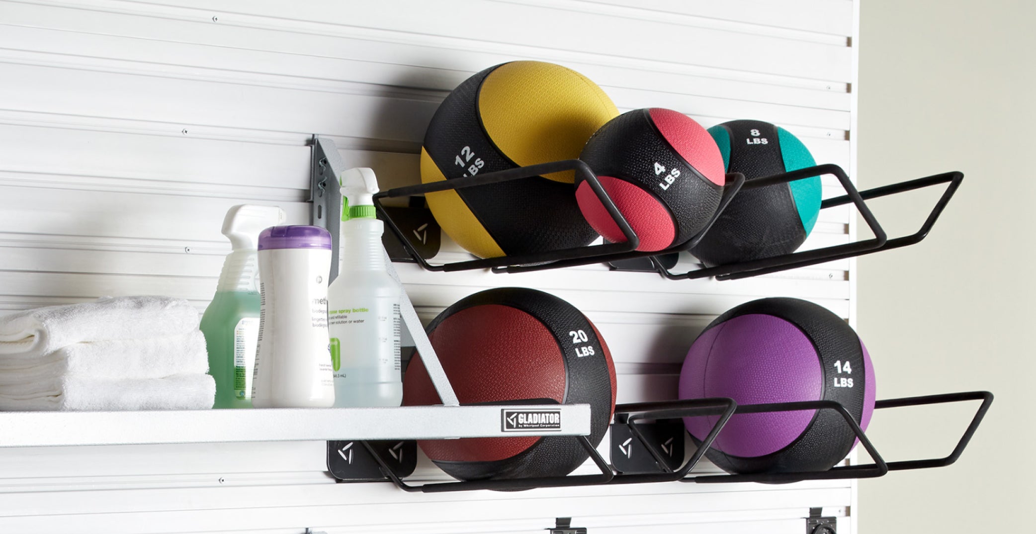 A Gladiator brand shelf organizing unit, complete with workout balls and gym equipment cleaning materials.