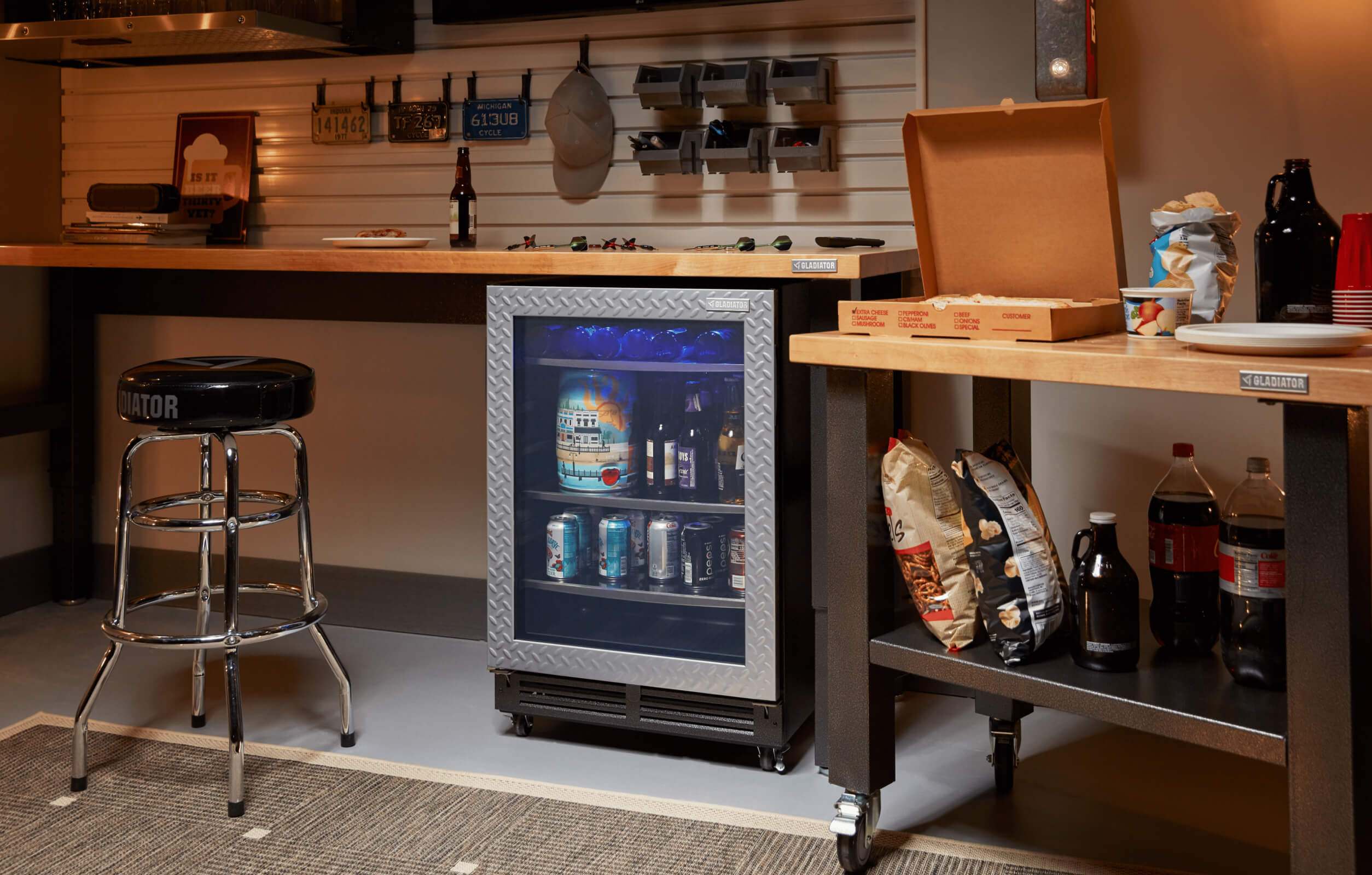 A Gladiator brand beverage refrigerator with snacks for movie enthusiasts.