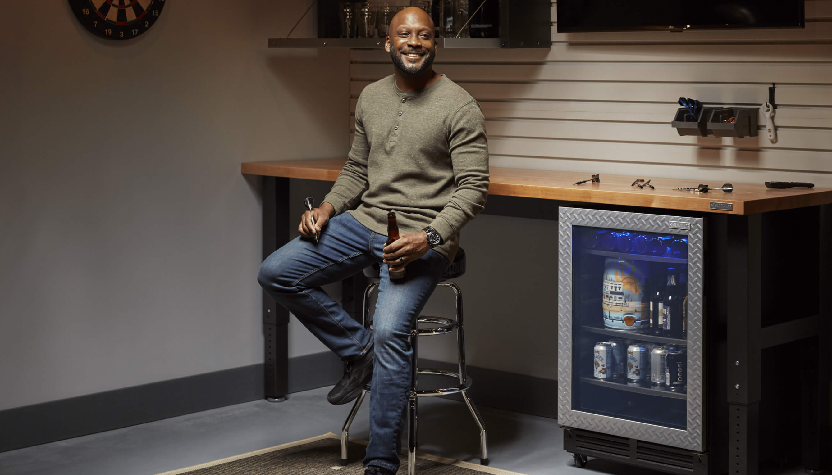 A person enjoying a cold beverage from their Gladiator brand beverage refrigerator.